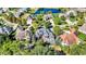 Areal photograph of homes in a neighborhood with a pond; the focal home has a deck and a trampoline at 3441 S Overlook Pass, New Palestine, IN 46163