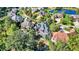 Areal view of homes surrounding a creek; the focal home has a deck, trampoline, and gray shingled roof at 3441 S Overlook Pass, New Palestine, IN 46163