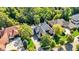 Aerial shot featuring a brick house with a lush yard, mature trees, and welcoming front porch at 3441 S Overlook Pass, New Palestine, IN 46163