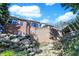 Backyard view of a brick house with stone retaining walls and lush landscaping at 3441 S Overlook Pass, New Palestine, IN 46163