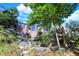 Beautiful backyard showcasing a stone staircase leading to a multi-story brick home at 3441 S Overlook Pass, New Palestine, IN 46163