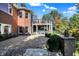 Spacious brick home featuring a paved patio and lush landscaping, creating an inviting outdoor living space at 3441 S Overlook Pass, New Palestine, IN 46163