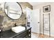 Well-lit bathroom with stone accent wall, contemporary fixtures, and stylish towel storage at 3441 S Overlook Pass, New Palestine, IN 46163