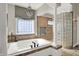 Bathroom with large soaking tub and elegant lighting fixtures at 3441 S Overlook Pass, New Palestine, IN 46163