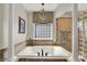 Bathroom with soaking tub, large pillars and glass enclosed shower at 3441 S Overlook Pass, New Palestine, IN 46163