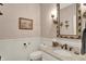 Elegant powder room with wainscoting, decorative wallpaper, and a marble vanity at 3441 S Overlook Pass, New Palestine, IN 46163