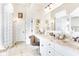 Bright bathroom featuring double sinks, granite countertops, white cabinets and framed mirrors at 3441 S Overlook Pass, New Palestine, IN 46163