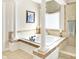 Bathroom with soaking tub, large pillars and glass enclosed shower at 3441 S Overlook Pass, New Palestine, IN 46163