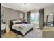 Comfortable bedroom featuring a chandelier, natural light, and a cozy bed at 3441 S Overlook Pass, New Palestine, IN 46163