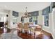 Sunlit dining room features hardwood floors, a chandelier, and large windows with decorative blinds at 3441 S Overlook Pass, New Palestine, IN 46163