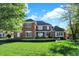 Beautiful brick home features manicured lawn and mature trees, creating a welcoming curb appeal at 3441 S Overlook Pass, New Palestine, IN 46163