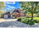 Charming two-story brick home featuring a well-manicured lawn and a paved driveway at 3441 S Overlook Pass, New Palestine, IN 46163