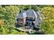 Aerial view of a brick two-story home with manicured landscaping, mature trees, and a welcoming front porch at 3441 S Overlook Pass, New Palestine, IN 46163