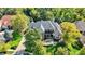 Aerial view of a beautiful brick home with well-kept lawn, mature trees, and inviting front porch at 3441 S Overlook Pass, New Palestine, IN 46163