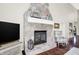 Close-up of the stunning stone fireplace with a white mantel, perfect for cozy evenings in this inviting living room at 3441 S Overlook Pass, New Palestine, IN 46163