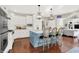 Bright and modern kitchen with white cabinetry, a blue island, stainless steel appliances, and hardwood floors at 3441 S Overlook Pass, New Palestine, IN 46163