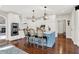 Open concept kitchen features white cabinets, a blue island with seating, and stainless steel appliances for cooking at 3441 S Overlook Pass, New Palestine, IN 46163