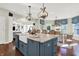 Spacious kitchen featuring a large island with a marble countertop, farmhouse sink, and decorative pendant lights at 3441 S Overlook Pass, New Palestine, IN 46163