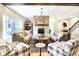 A cozy living room boasts a stone fireplace and an open floor plan with lots of natural light at 3441 S Overlook Pass, New Palestine, IN 46163