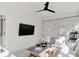 Bright and airy living room featuring white brick walls, modern ceiling fan, and stylish decor at 3441 S Overlook Pass, New Palestine, IN 46163