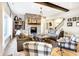 Cozy living room with stone fireplace, hardwood floors, and comfortable seating arrangement at 3441 S Overlook Pass, New Palestine, IN 46163