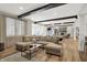 Open floor plan of the lower level with a spacious sectional couch and hardwood floors at 3441 S Overlook Pass, New Palestine, IN 46163