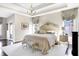 Luxurious main bedroom with a tray ceiling, chandelier, large bed, and stylish window treatments at 3441 S Overlook Pass, New Palestine, IN 46163