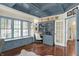 Cozy home office with blue coffered ceilings, window seat, built-in shelving, and hardwood floors at 3441 S Overlook Pass, New Palestine, IN 46163