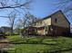 Large backyard with mature trees and green grass, providing ample space for outdoor activities and relaxation at 8429 Admirals Cv, Indianapolis, IN 46236
