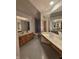 Bright primary bathroom featuring dual sinks, vanity and lots of mirror space with overhead lighting at 8429 Admirals Cv, Indianapolis, IN 46236
