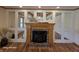 Elegant fireplace with brick hearth and built-in mirrored cabinets at 8429 Admirals Cv, Indianapolis, IN 46236