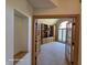 Spacious home office featuring custom built-in shelving, a large window, and neutral carpet at 8429 Admirals Cv, Indianapolis, IN 46236