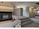 Cozy living room features a fireplace, vaulted ceiling, and convenient access to the bathroom at 8429 Admirals Cv, Indianapolis, IN 46236