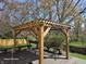 Wooden pergola with string lights, offering a charming outdoor space for seating and entertaining at 8429 Admirals Cv, Indianapolis, IN 46236