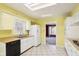 Kitchen with white cabinets, tile floor, and double sink at 9706 N Glen Dr, Mooresville, IN 46158