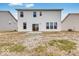 View of the home's backyard with a sliding glass door, patio, and grass at 1082 Stubble Run, Danville, IN 46122