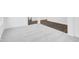 Finished basement area showcasing a transition from carpet to wood flooring and supportive beams at 1082 Stubble Run, Danville, IN 46122