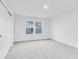 This bedroom features neutral carpeting, white walls, and a spacious closet at 1082 Stubble Run, Danville, IN 46122
