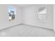 This bedroom features neutral carpeting, white walls, and a view of the backyard at 1082 Stubble Run, Danville, IN 46122