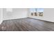 Spacious living room featuring gray wood floors and large windows for ample natural light at 1082 Stubble Run, Danville, IN 46122