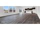 Open-concept living space showcasing wood floors connecting to the kitchen and dining area at 1082 Stubble Run, Danville, IN 46122