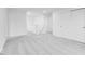 Open loft area with soft carpeting, natural light, and versatile space for entertainment or relaxation at 1082 Stubble Run, Danville, IN 46122