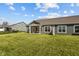 Spacious backyard featuring a covered patio, lush lawn, and gray siding at 16689 Cattle Hollow Ln, Noblesville, IN 46060