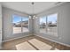 Bright dining room featuring two large windows and an elegant chandelier at 16689 Cattle Hollow Ln, Noblesville, IN 46060