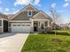 Charming craftsman-style home with a two-car garage, well-manicured lawn, and covered front porch at 16689 Cattle Hollow Ln, Noblesville, IN 46060