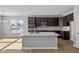 Modern kitchen with stainless steel appliances, a center island, and dark cabinetry at 16689 Cattle Hollow Ln, Noblesville, IN 46060