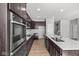 Beautiful kitchen features stainless appliances, quartz countertops, and wood flooring at 16689 Cattle Hollow Ln, Noblesville, IN 46060