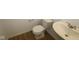 Simple bathroom with white sink, toilet, and wood-look floor at 1837 James Pierce Dr, Shelbyville, IN 46176