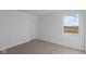 A cozy bedroom features neutral carpeting and a window view at 1837 James Pierce Dr, Shelbyville, IN 46176
