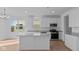 Bright kitchen featuring white cabinetry, stainless steel appliances, large island, and a pantry at 1837 James Pierce Dr, Shelbyville, IN 46176